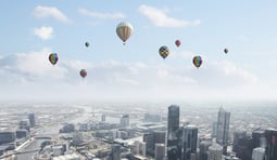 Conceptual image with colorful balloons flying high in sky.jpeg